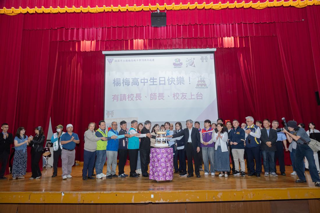 舞台上人數眾多的大合照，前方擺放校慶蛋糕。